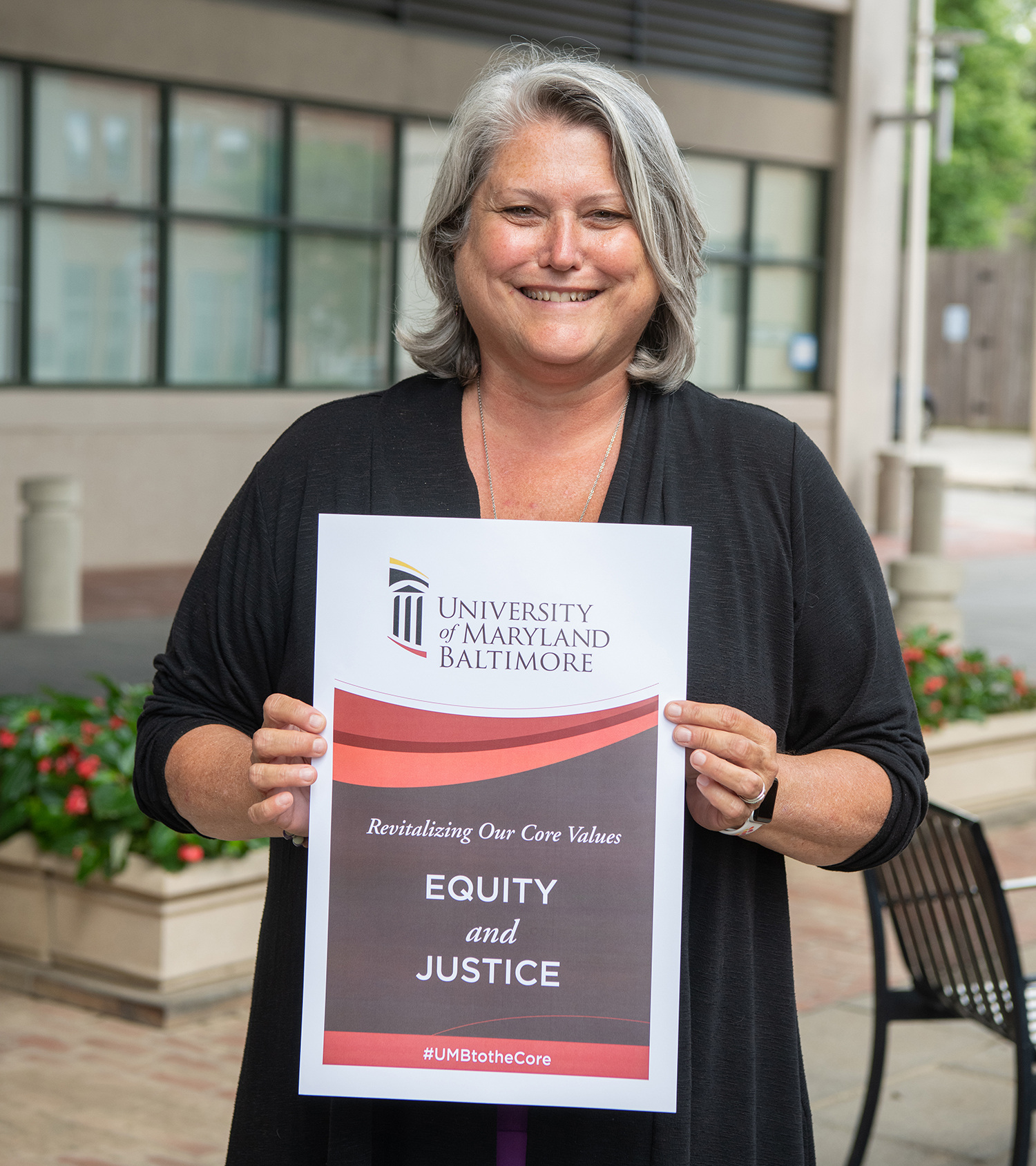 Judy Postmus holding Equity and Justice sign