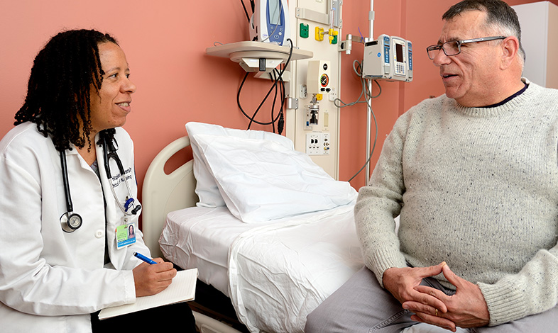 Current Concepts in the Evaluation and Management of Lipid Disorders event photo with a provider and a patient interacting 