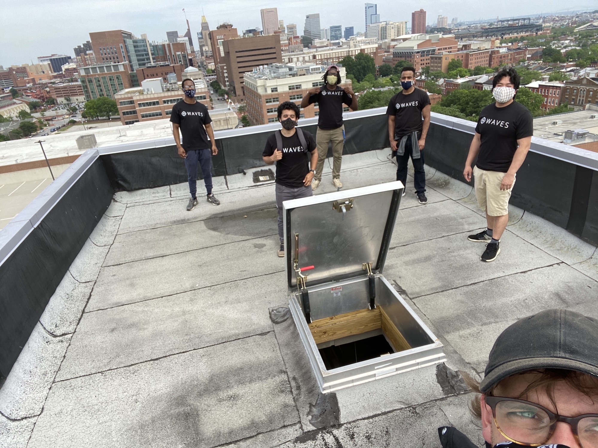 Project Waves team installing wireless antenna on the UMB Poppleton parking garage