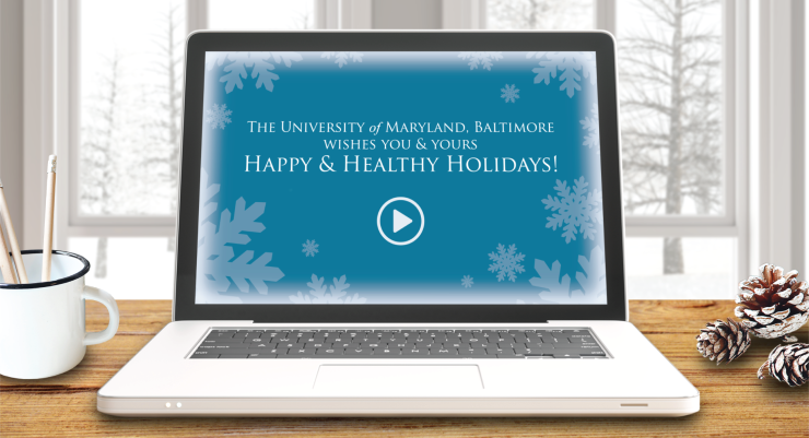 UMB computer laptop with holiday scene and blue snowflakes