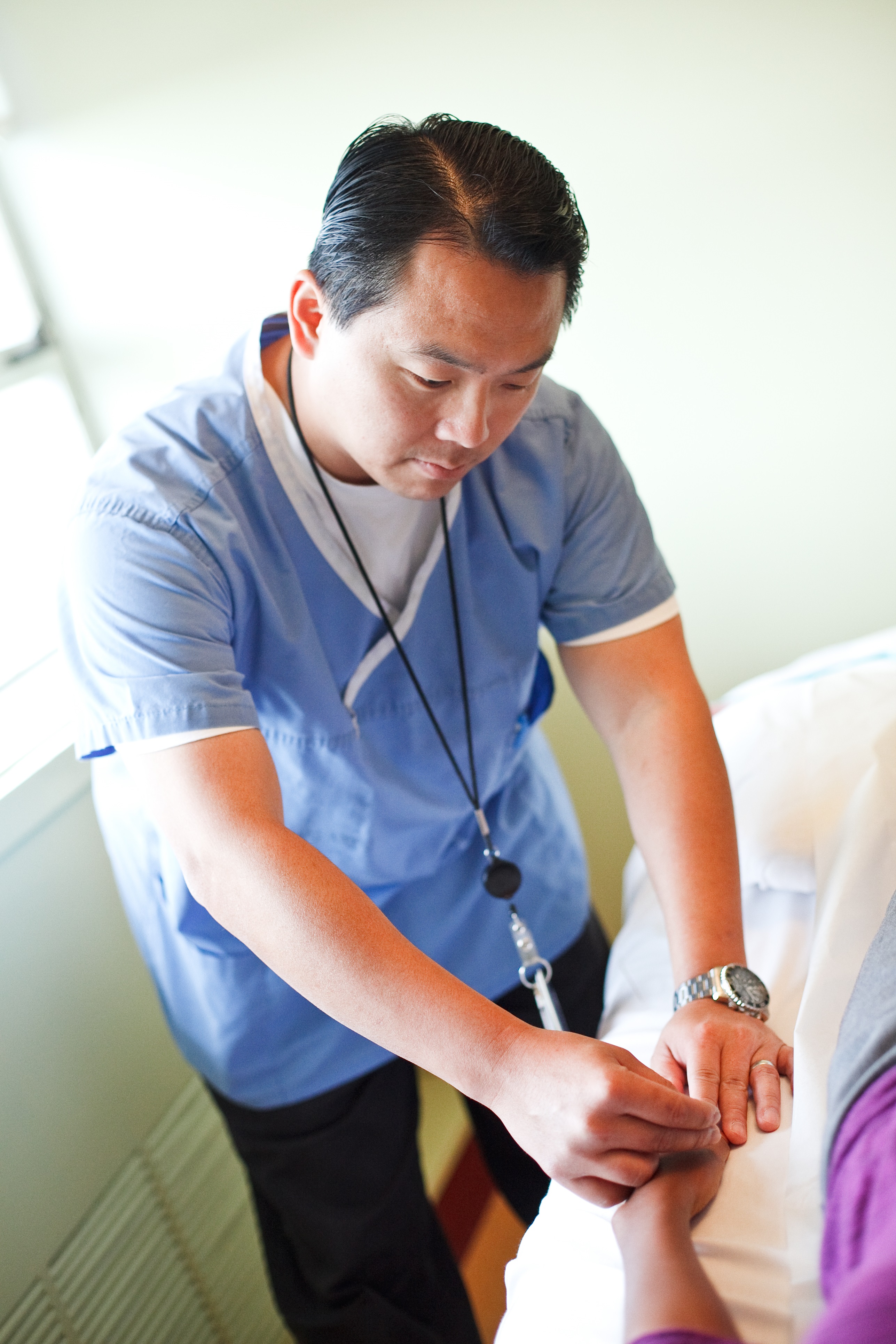 Marcos Hsu examining a patient