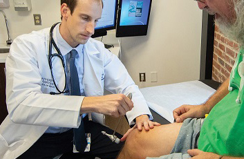 Doctor treating pain patient