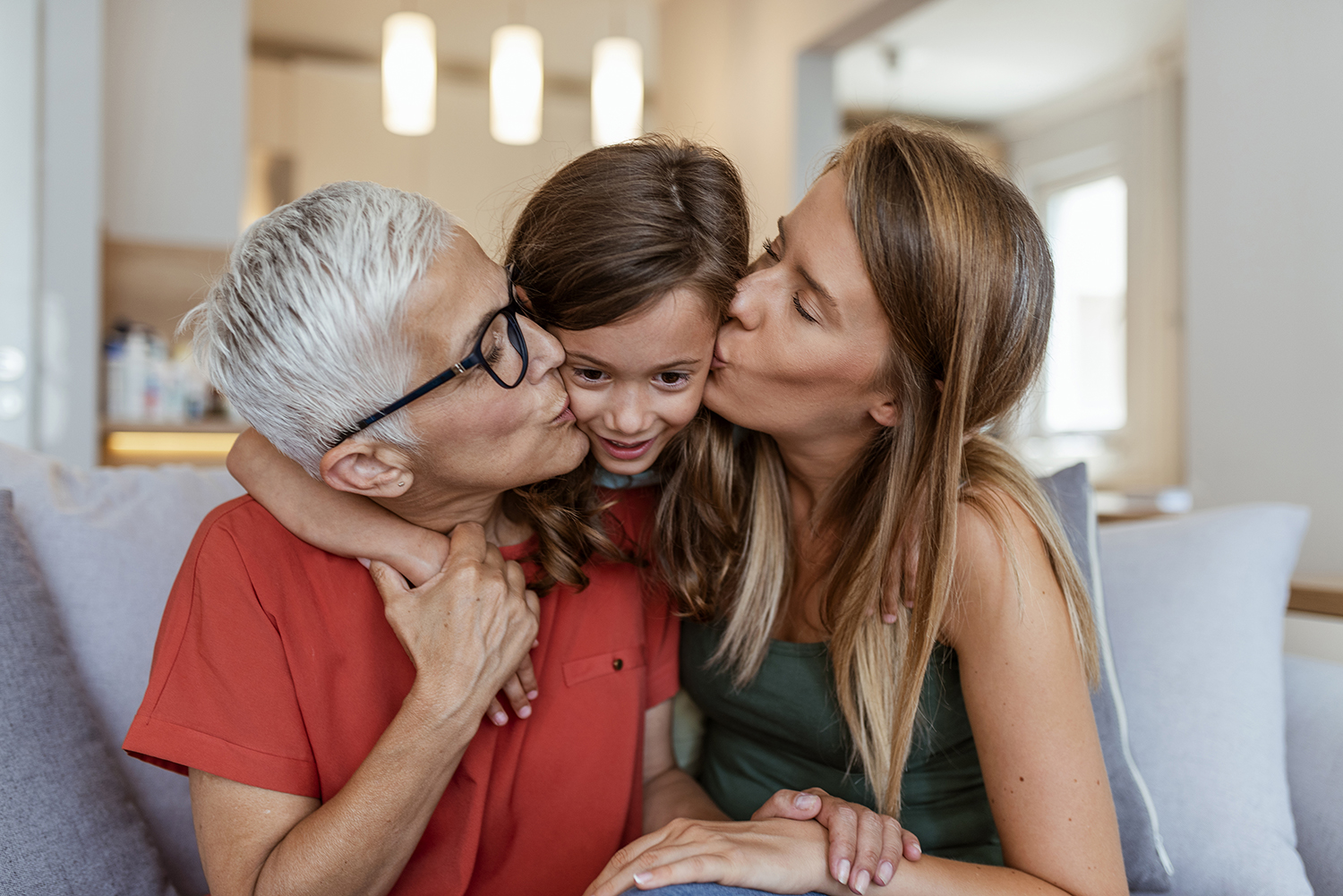 little girl being kissed by caregivers