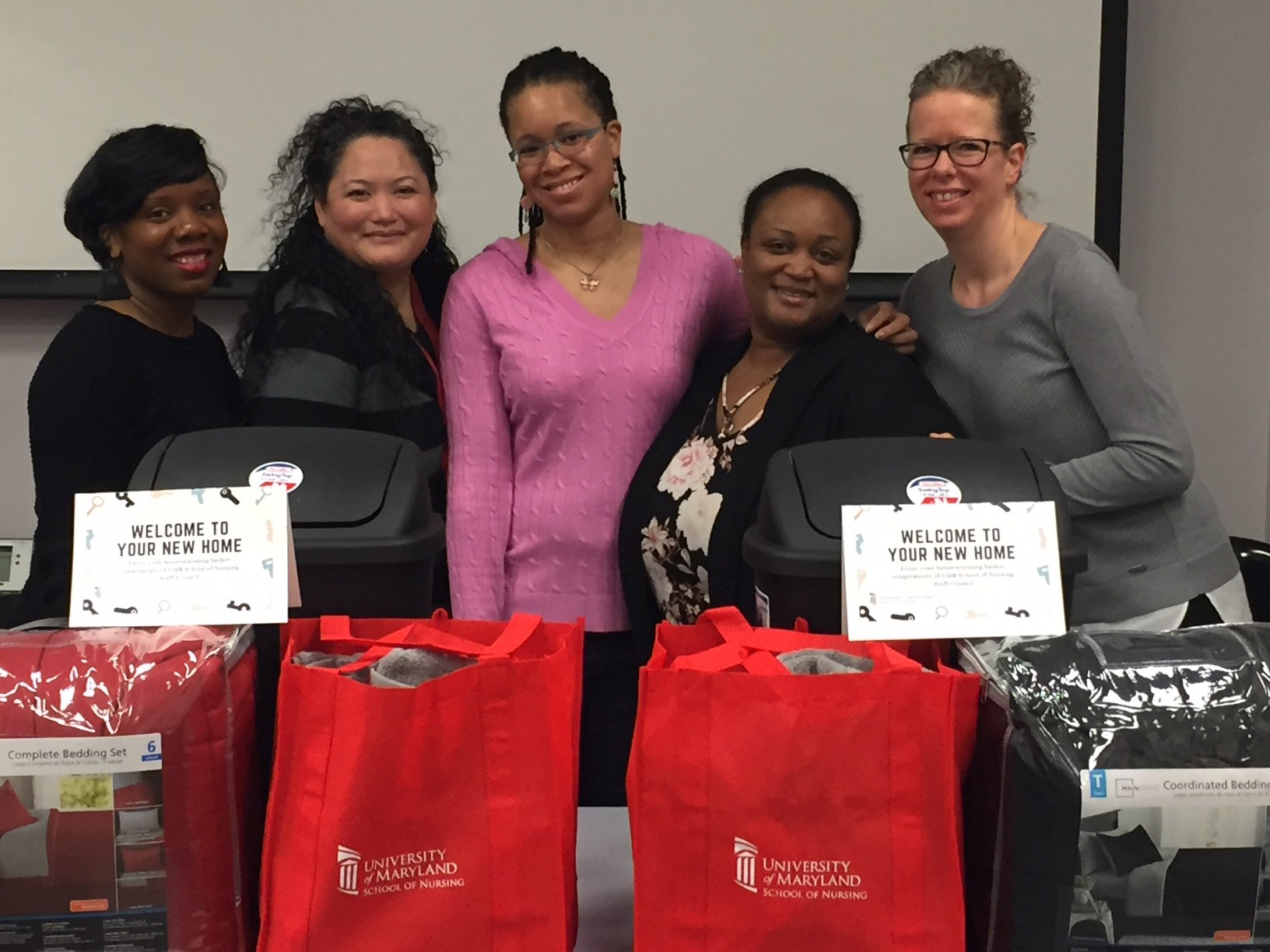 Staff Council members (from left) Terria McClain, Jennifer Volberding, Mikki Coleman, Tara Wells, and Kristy Novak assemble housewarming baskets for the Weinberg House