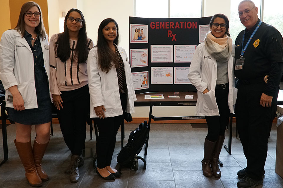 Student pharmacists with UMB Police Corporal John R. Jones during Drug Take-Back Day