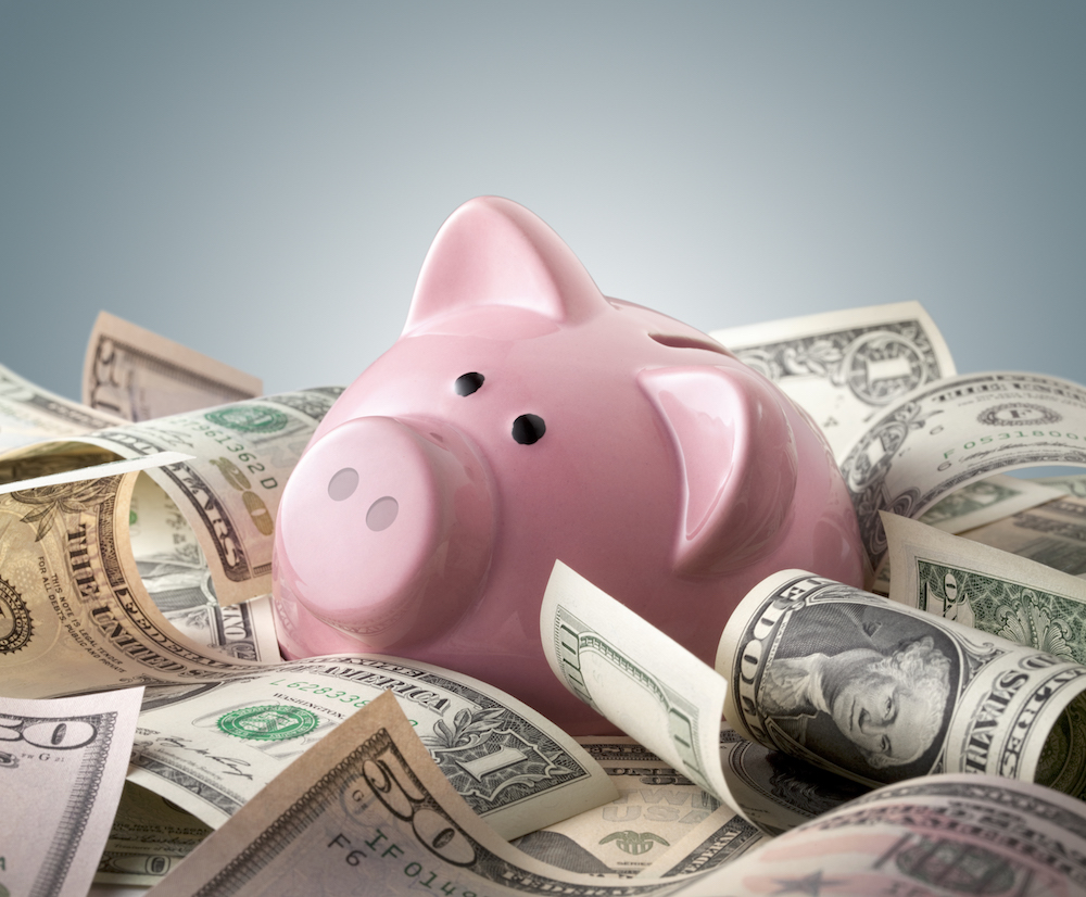 Piggy bank with dollar bills