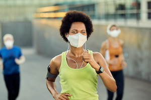 Woman running in a face mask