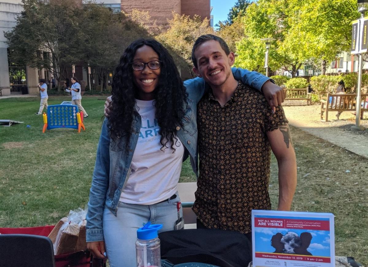 Two students hugging at a tabling event