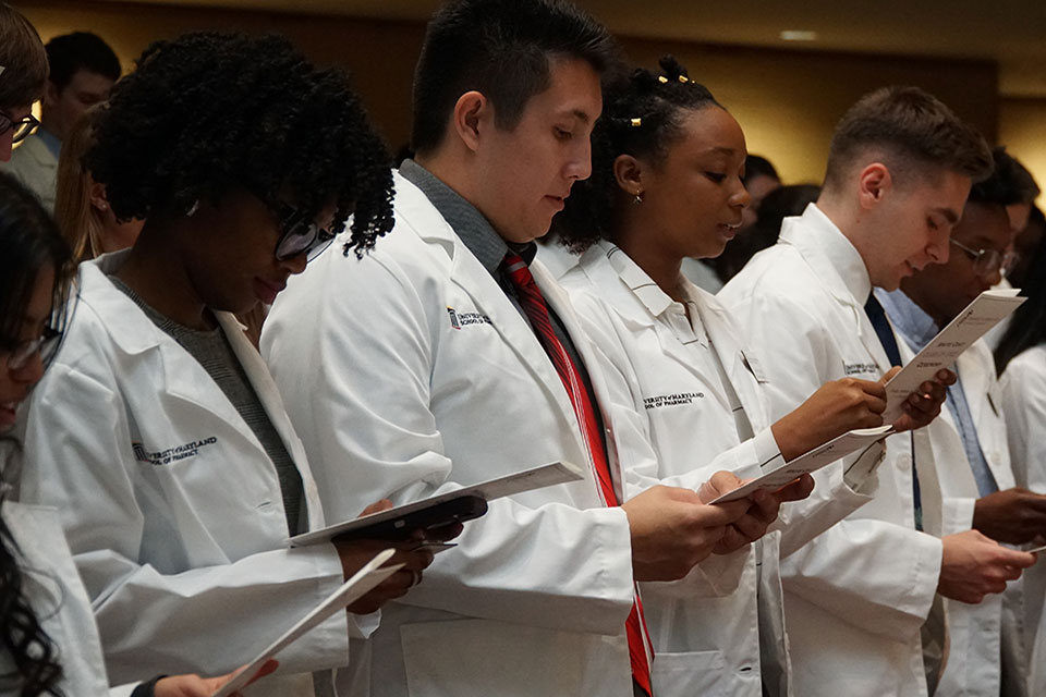 Student pharmacists recite the School's Honor Code during the White Coat Ceremony.