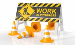Work in Progress sign with orange cones