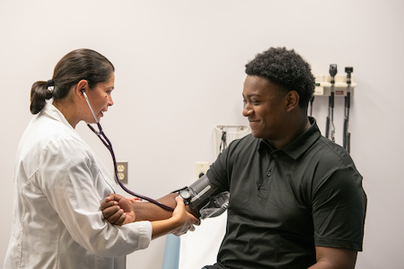 NP giving an eye exam to a teen patient 