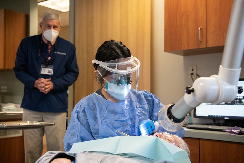 Dental student works on patient.