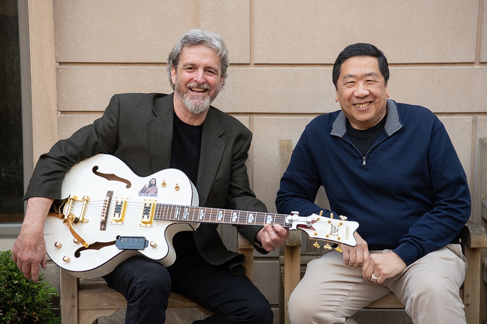 Pat Geraghty (left) holds his guitar next to Intellectual Property and Entrepreneurship Clinic supervising attorney Ed Yee, JD ’97.