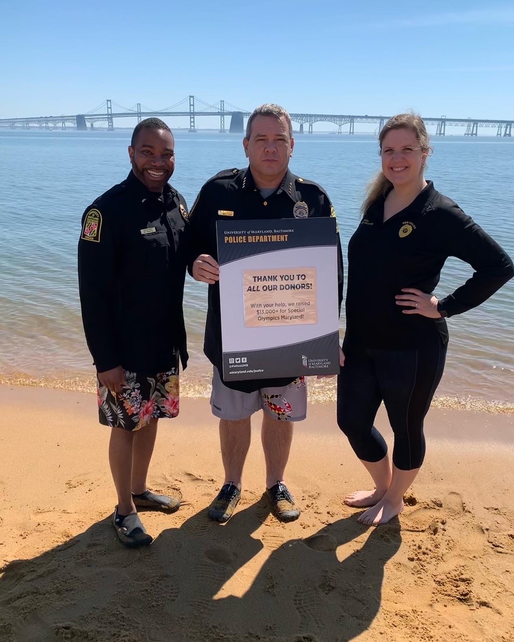 Lt. Matthew Johnson, Chief Thomas Leone, and PIO Carin Morrell with a sign thanking donors