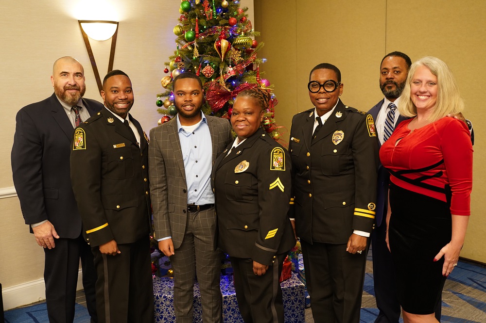 Awardees standing in front of a Christmas tree