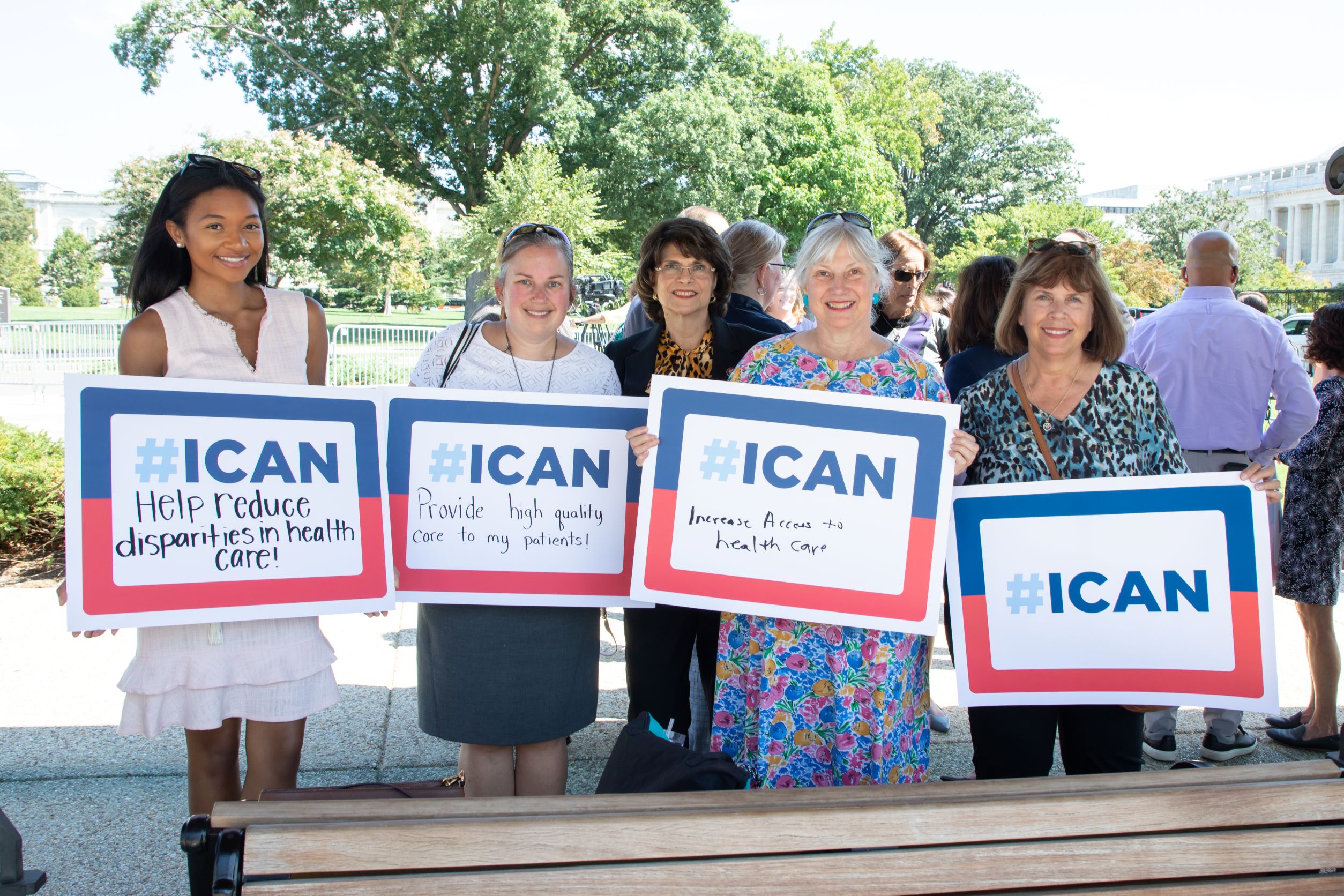 students, congresswoman, and faculty posing and holding posters that say 