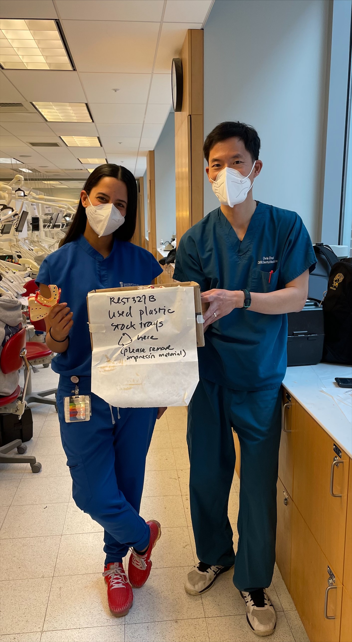 Melisa White Valencia (left) and Dr. Chris Choi (right) hold up their collection box for impression trays