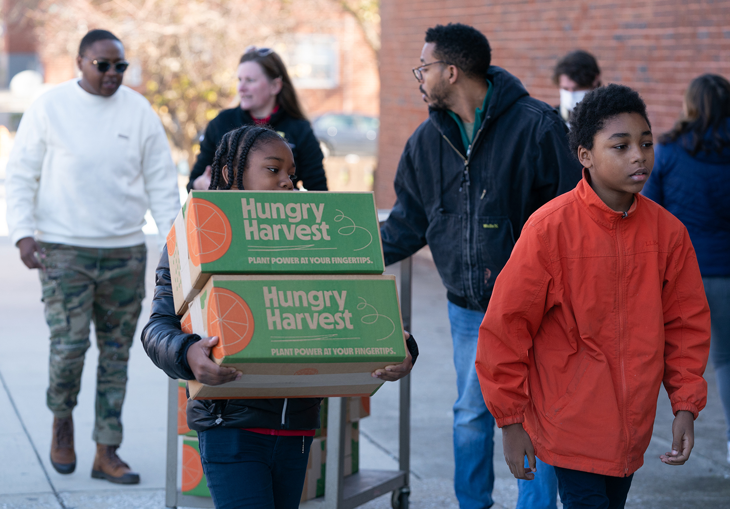 Kids carry Thanksgiving meal boxes
