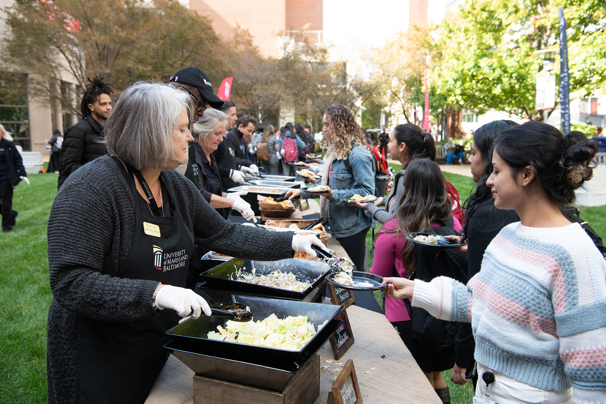 School of Social Work Dean Judy Postmus serves food during the Founders Week Student Cookout on Oct. 18.