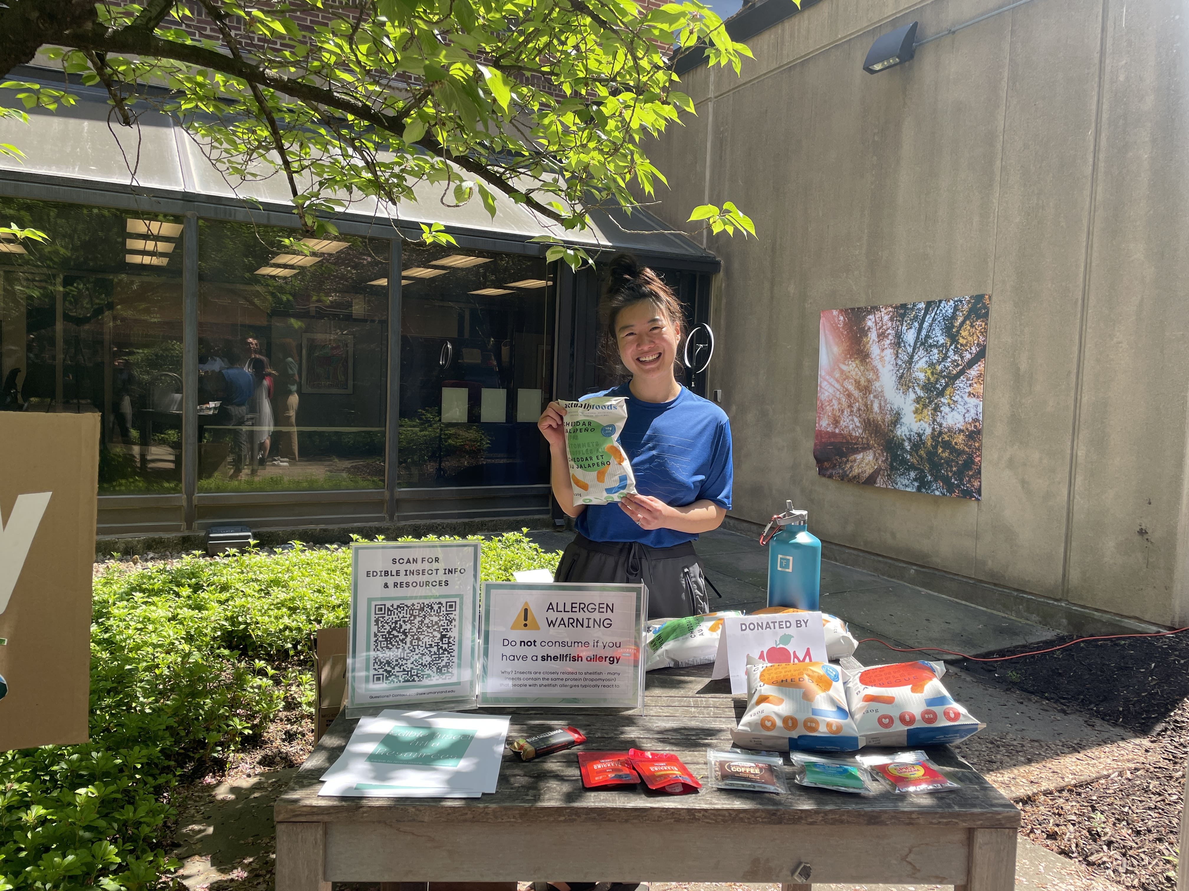 Lucy Zhao at ECO Fest holding cricket snacks