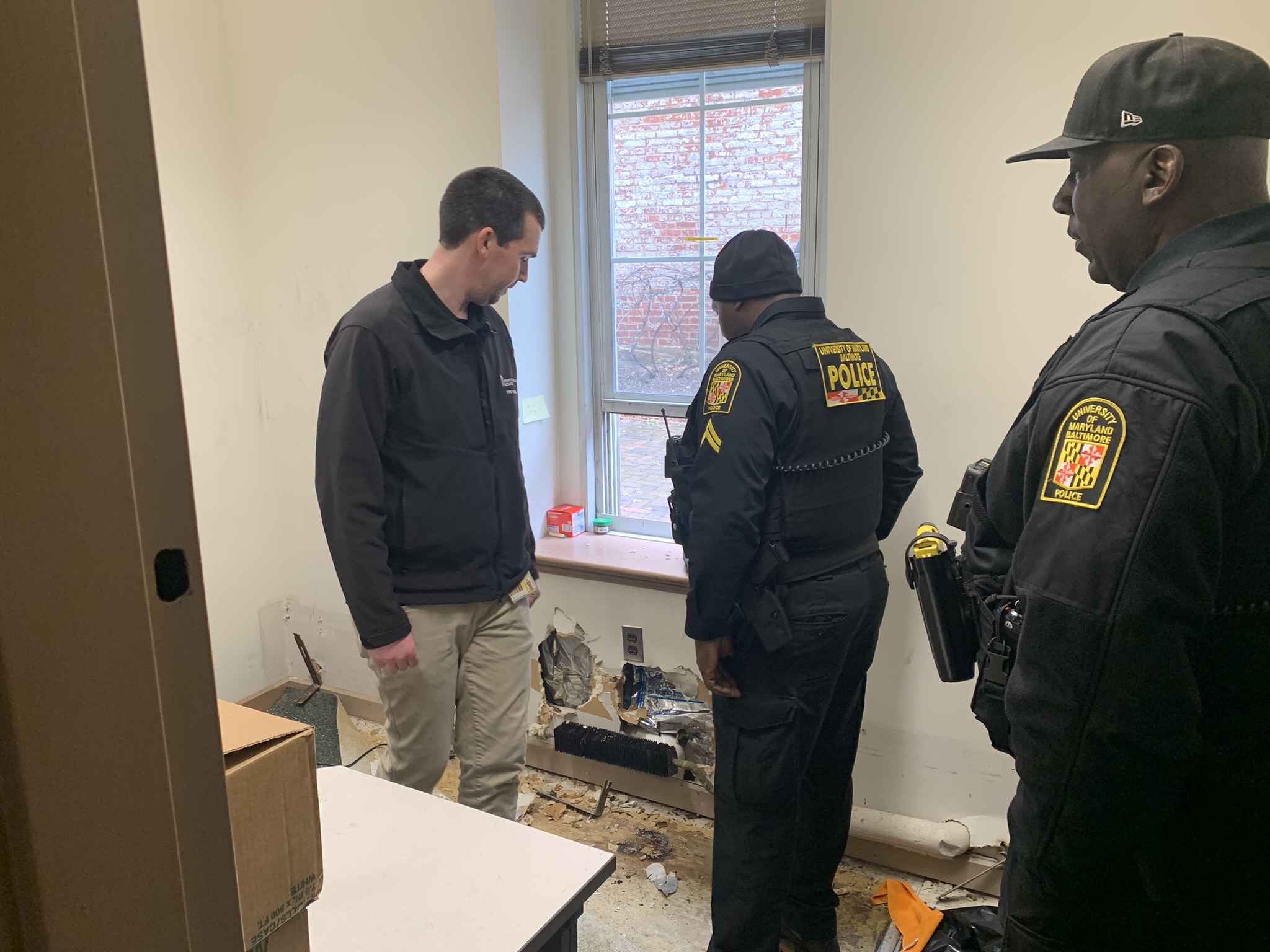 UMB Fire Marshal and UMB police officers examine damage from space heater fire