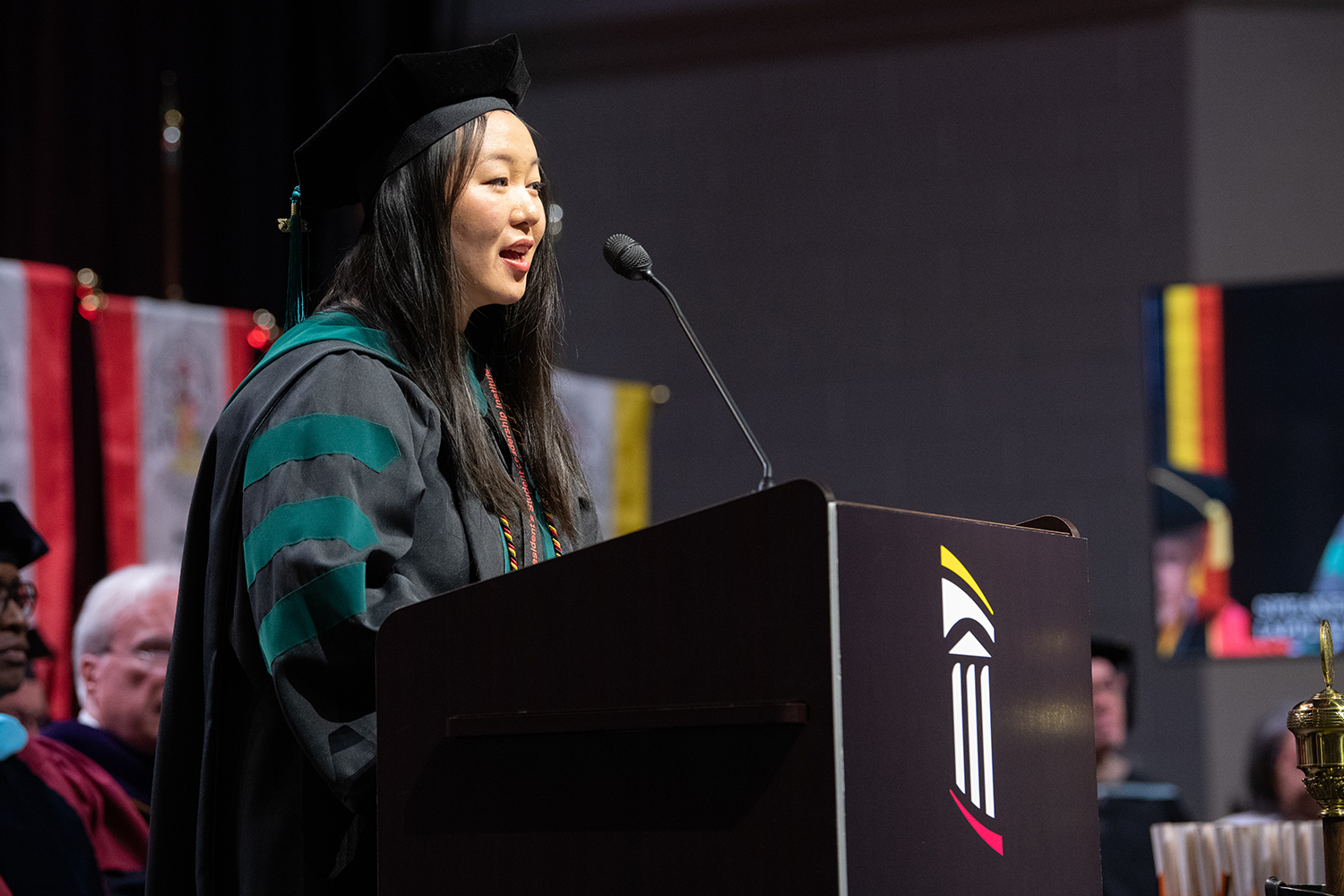 Joanna Ye speaking at the Universitywide commencement