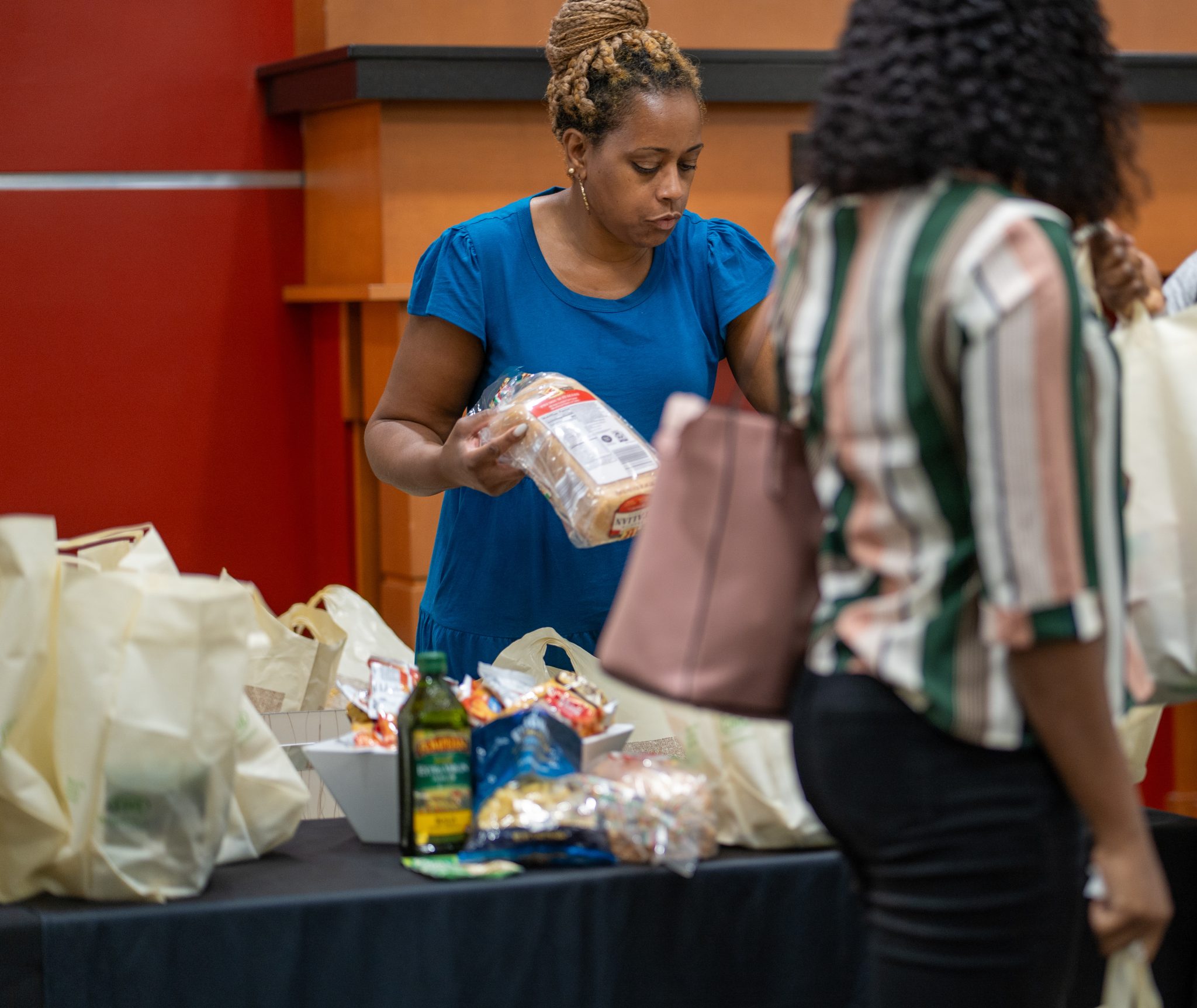 Jole’ Ruff, community program specialist, Division of Student Affairs, who manages the daily operations of the Student Pantry, hands out food and other products during a pop-up event this fall.