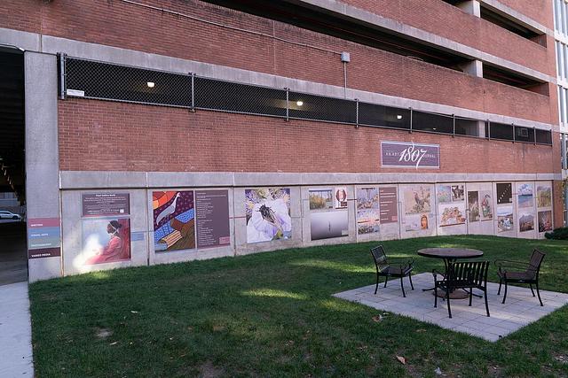 Brick and concrete wall with vinyl images of art in gallery