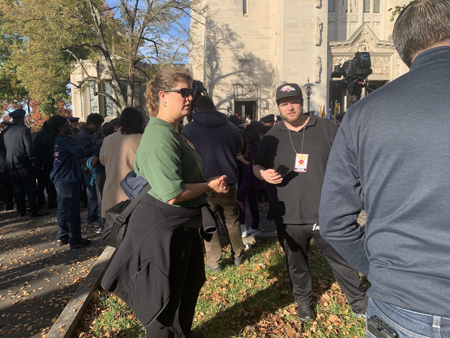 Carin Cardella, public information officer for UMB Police and Public Safety, answers questions for members of the media outside a funeral for one of the Baltimore City Fire Department members. 