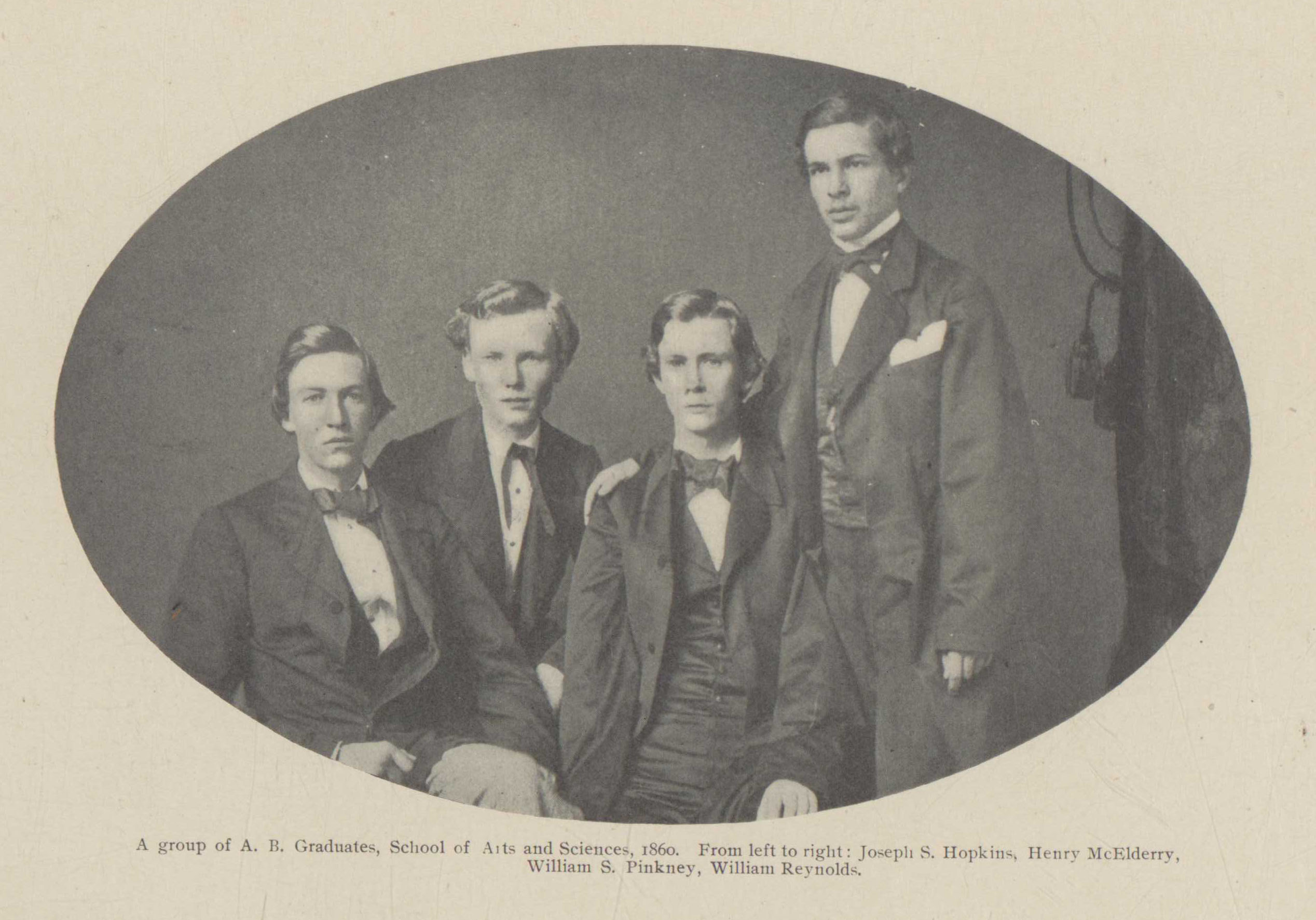 Rounded photograph of four men, three are sitting one is standing. They are dressed in 1860s suits.