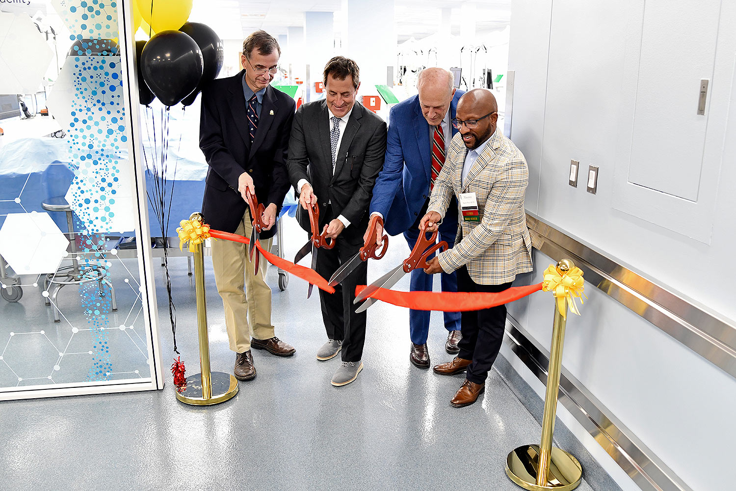 Adam Puche, Mark Gladwin, Bruce Jarrell, and Maurice Reid cut a ribbon on the new facility. 