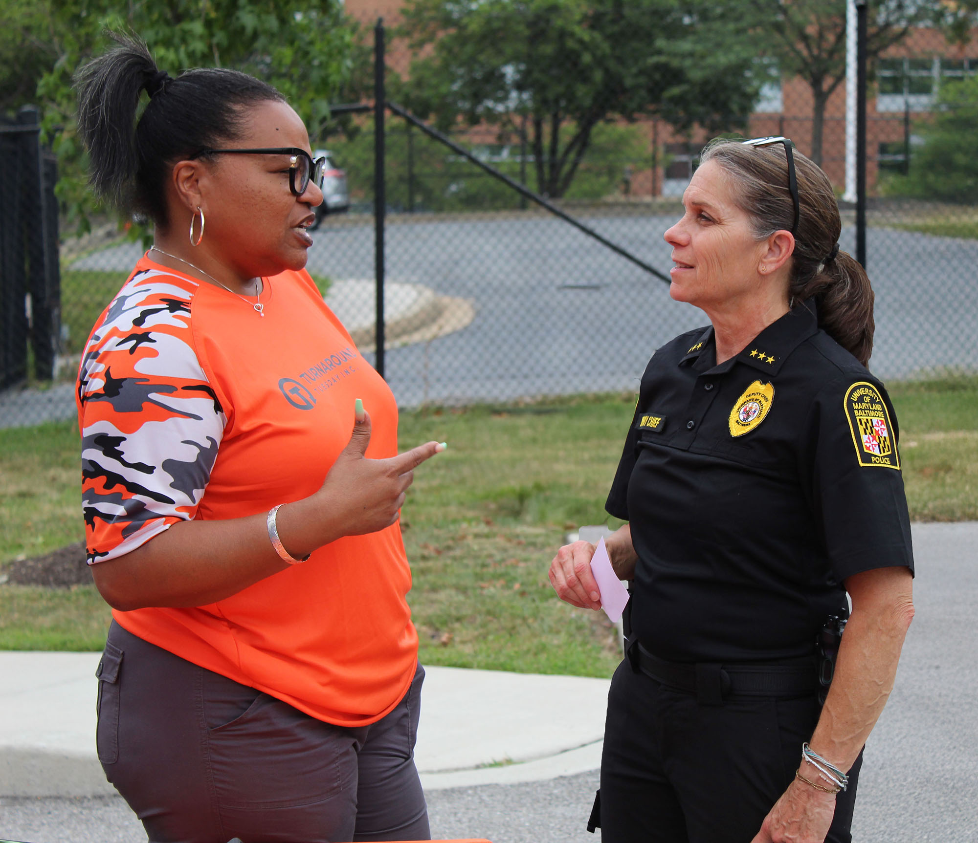 Photo: Deputy Chief Barbara Duncan, right, chats with an attendee at UMB’s National Night Out on Aug. 5.