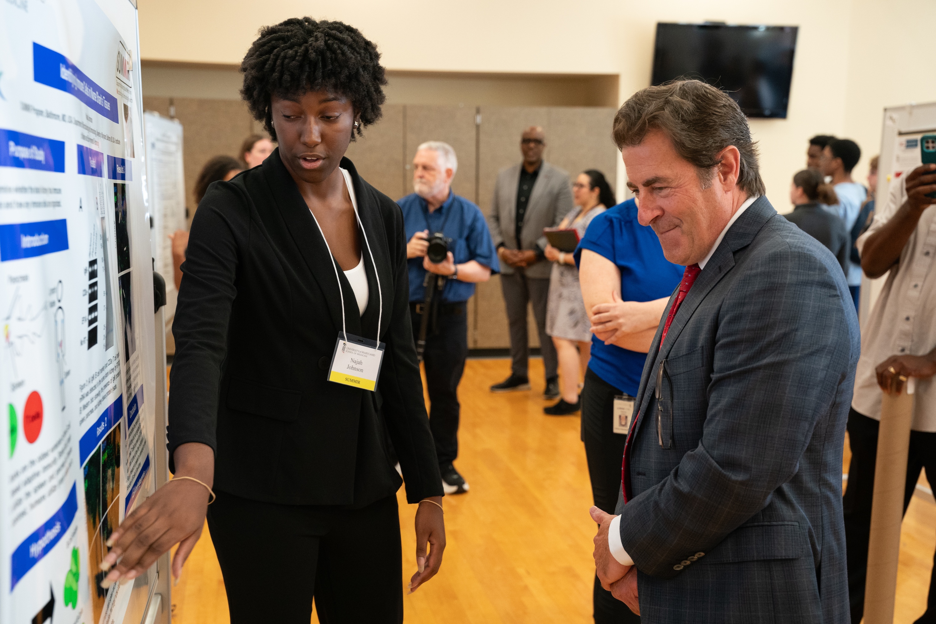 Najah Johnson shows her research project “Sharks and the Science of Immunity” to School of Medicine Dean Mark Gladwin.