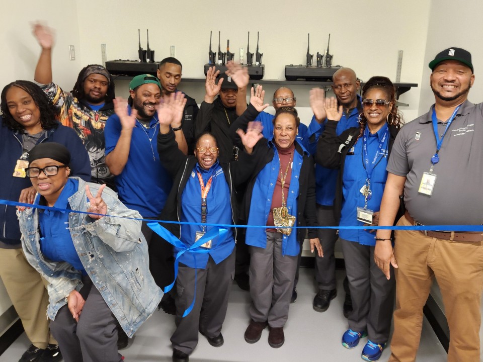 (Photo: Members of the EVS team that service the School of Dentistry prepare for the ribbon cutting for their new break space.)