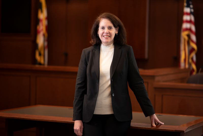 Person in business attire standing in a courtroom