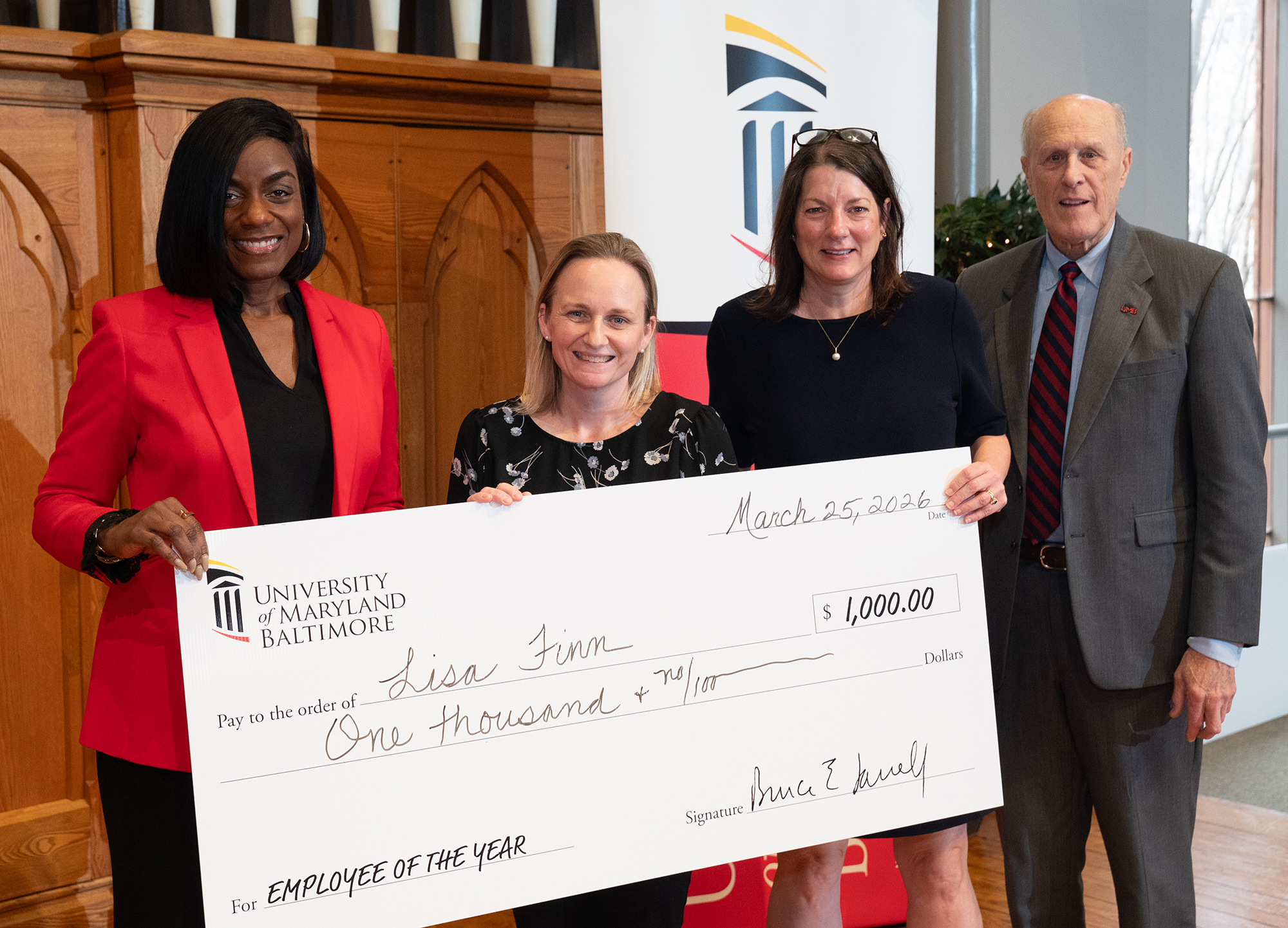 Lisa Finn (second from left) stands with (from left) Malika Monger, Agnes Ann Feemster, and Bruce Jarrell.