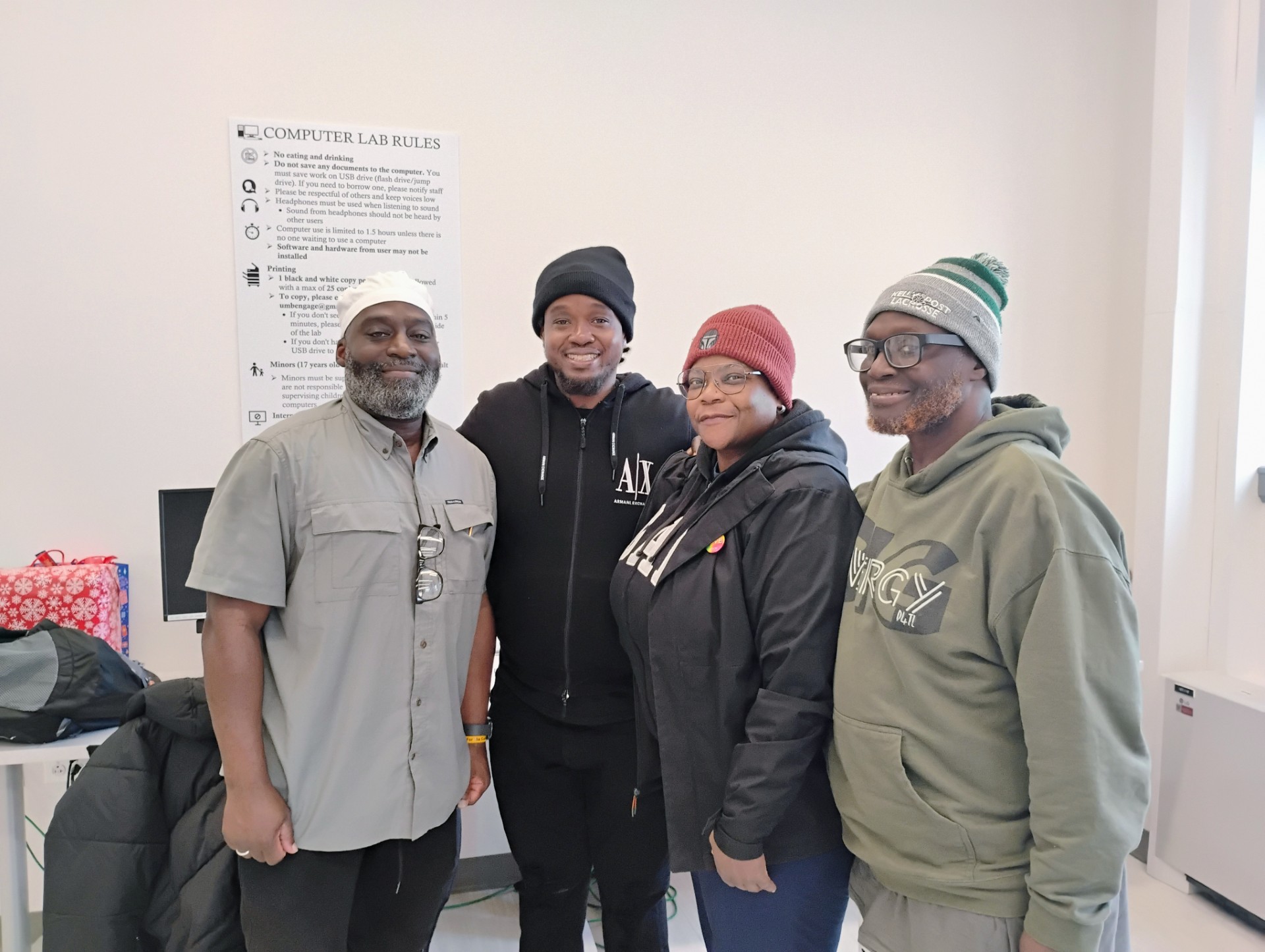 Maryland Justice Project staff and participant pictured standing in the UMB Community Engagement Center's computer lab