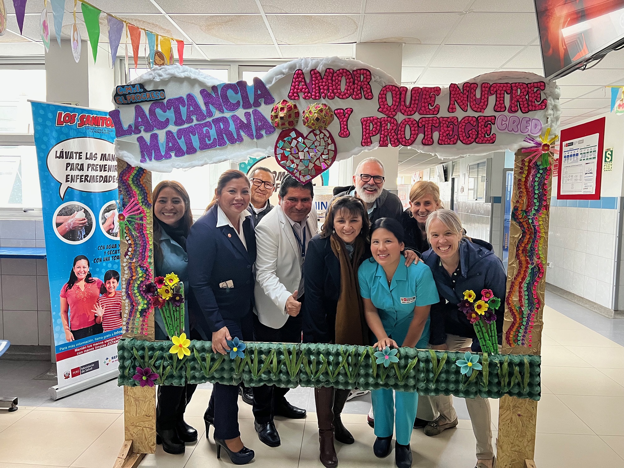 Jay Unick poses with medical professionals in Peru with a cutout frame around them 