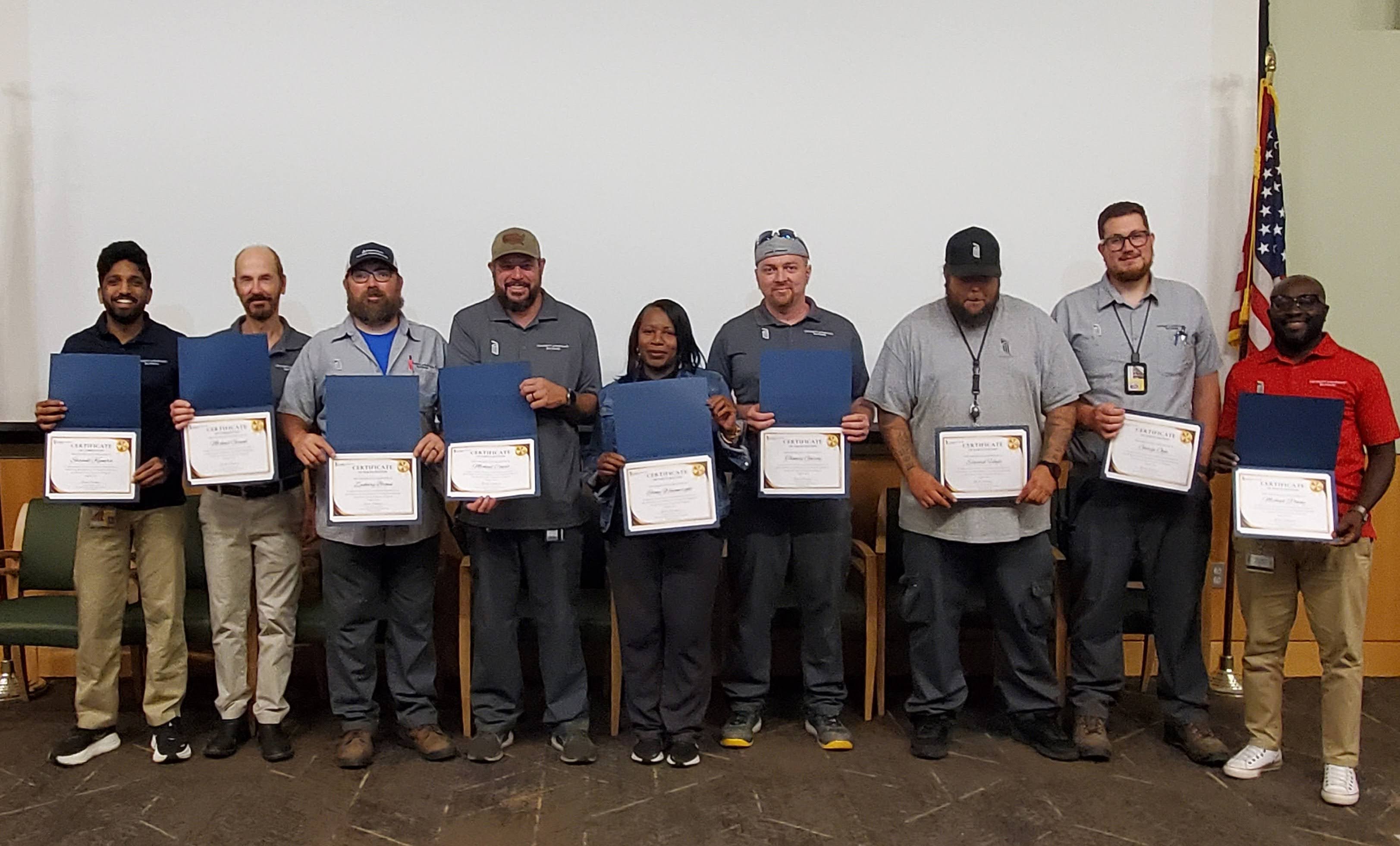 Members of the O&M team pose with awards