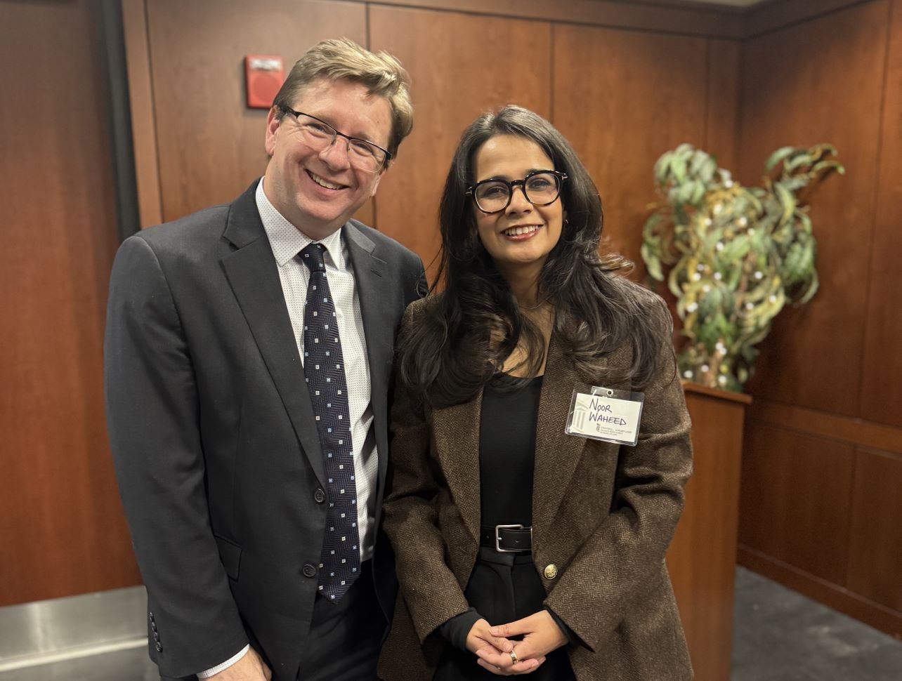 Professor Peter Danchin, director, International and Comparative Law Program, and Noor Waheed, Maryland Journal of International Law editor-in-chief posing together at a celebratory dinner and smiling