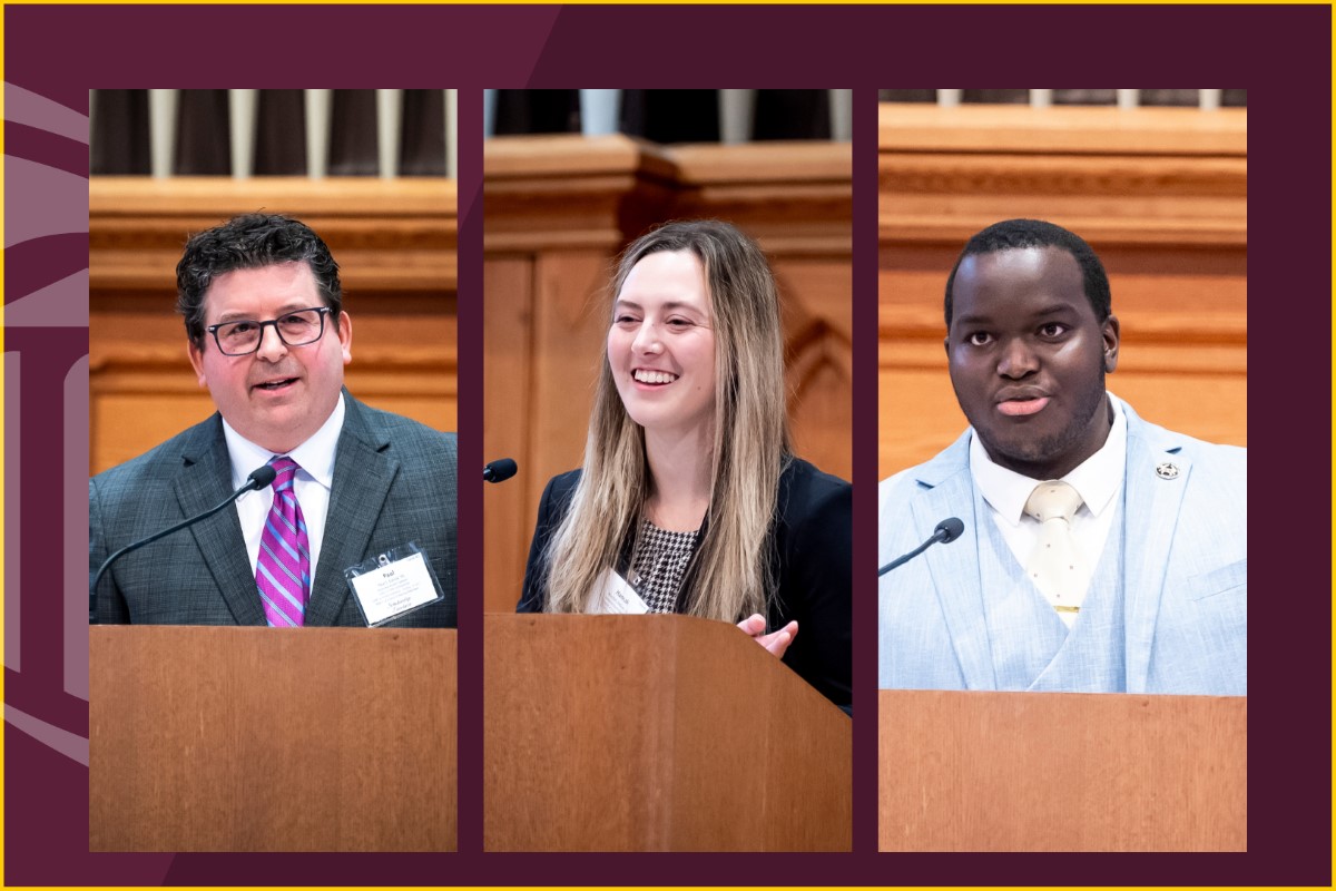 Pictured speaking at a podium from left to right, Paul Caiola, JD ’95, Hannah DeGraw ’26, and Rasul Wright ’26 