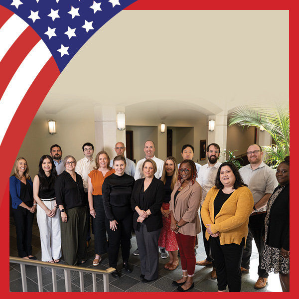 UMB Celebrates America at 250 with U.S. flag look and photo of the staff of CHHS