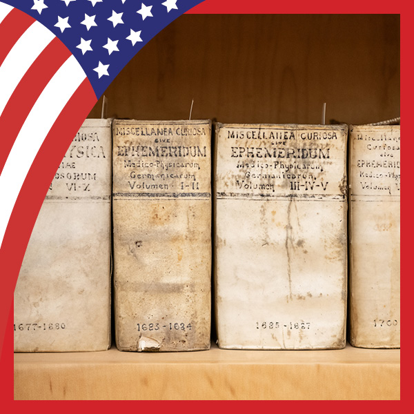 UMB Celebrates America at 250 with U.S. flag and a photo of old medical books