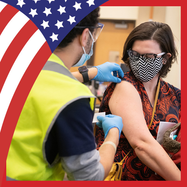 UMB Celebrates America at 250 with U.S. flag theme and a woman getting a vaccine shot from a health professional