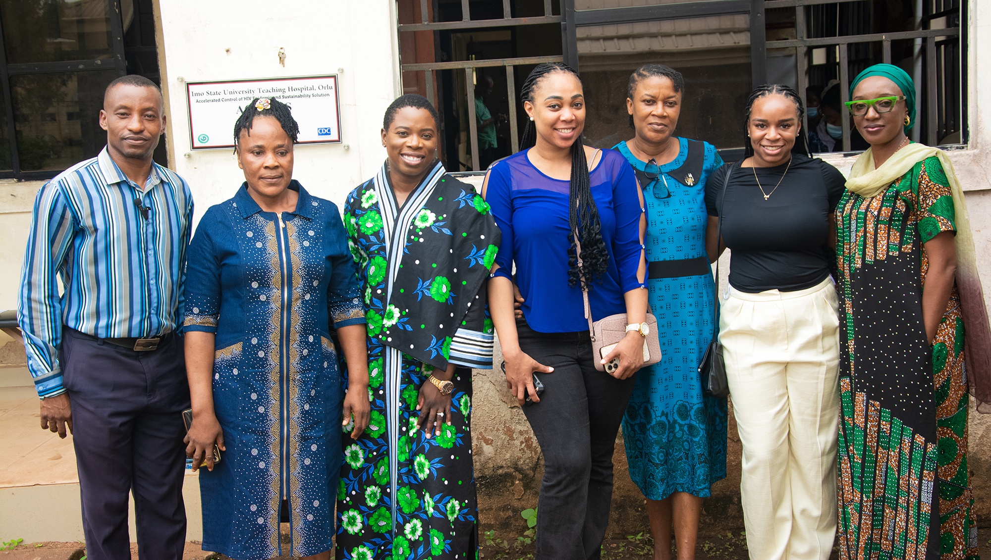 Charlotte Nwogwugwu standing outside a building with others in Nigeria