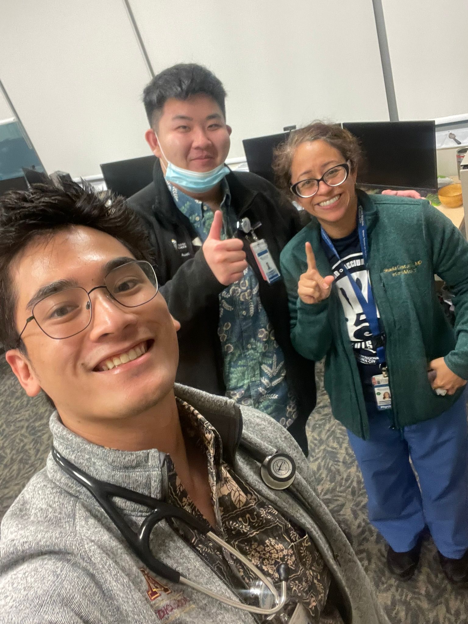 Austin Kim smiles and gives a thumbs up with Kai Akimoto and Shadia Constantine, MD
