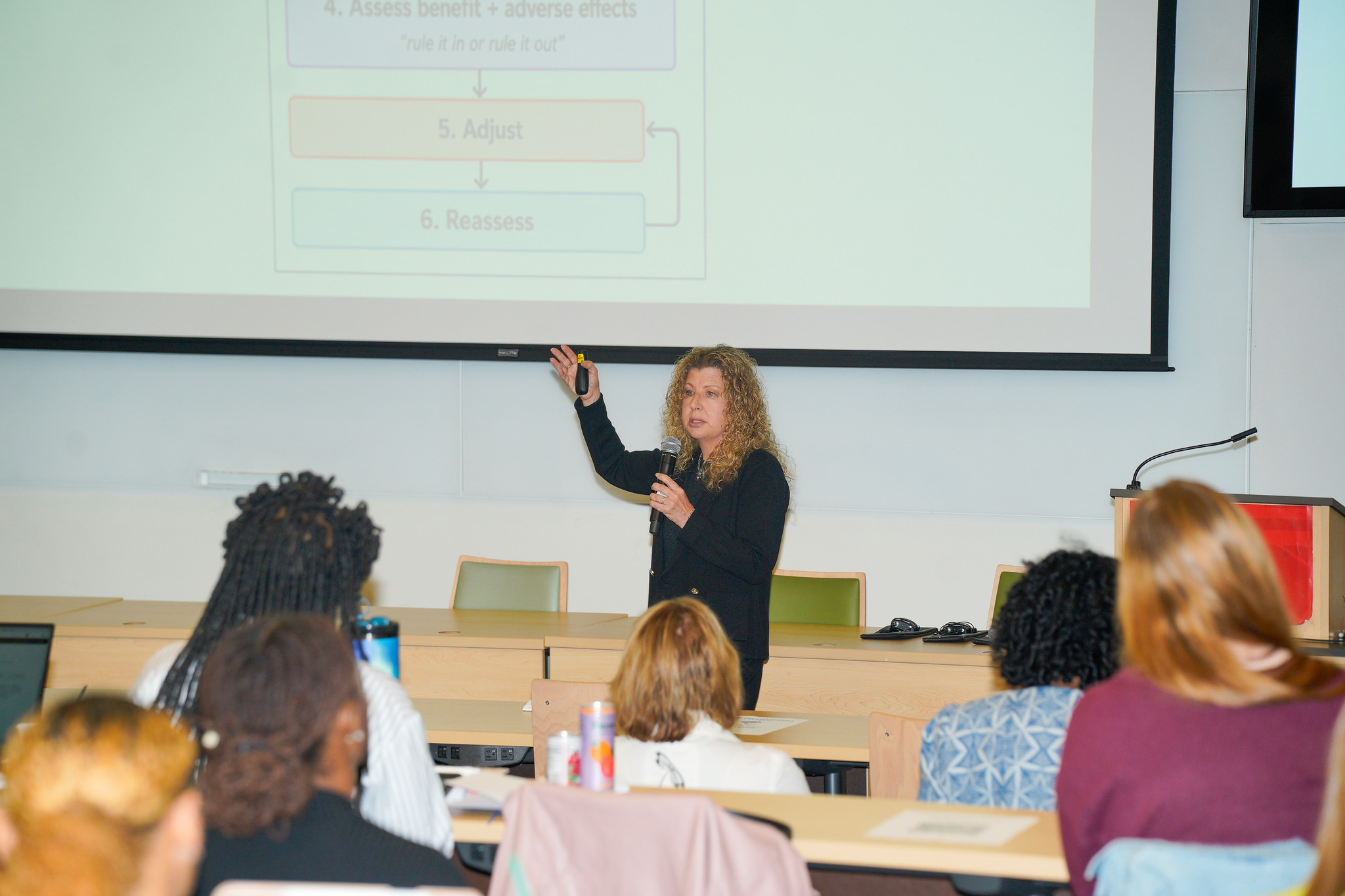Bonnie Goldstein gives a lecture in front a classrom full of students.