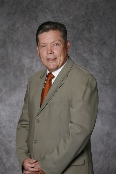 Full-color headshot of Professor Emeritus Jerome Deise with gray background