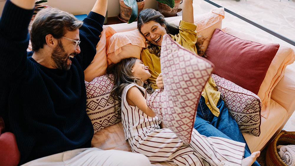 Family celebrates together on a cozy couch