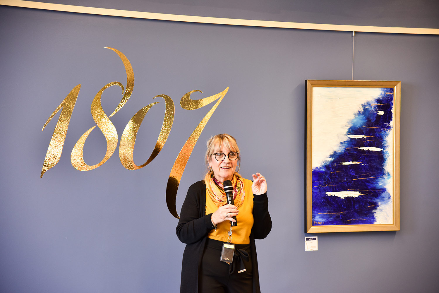 Patricia Hoffman in front of her artwork